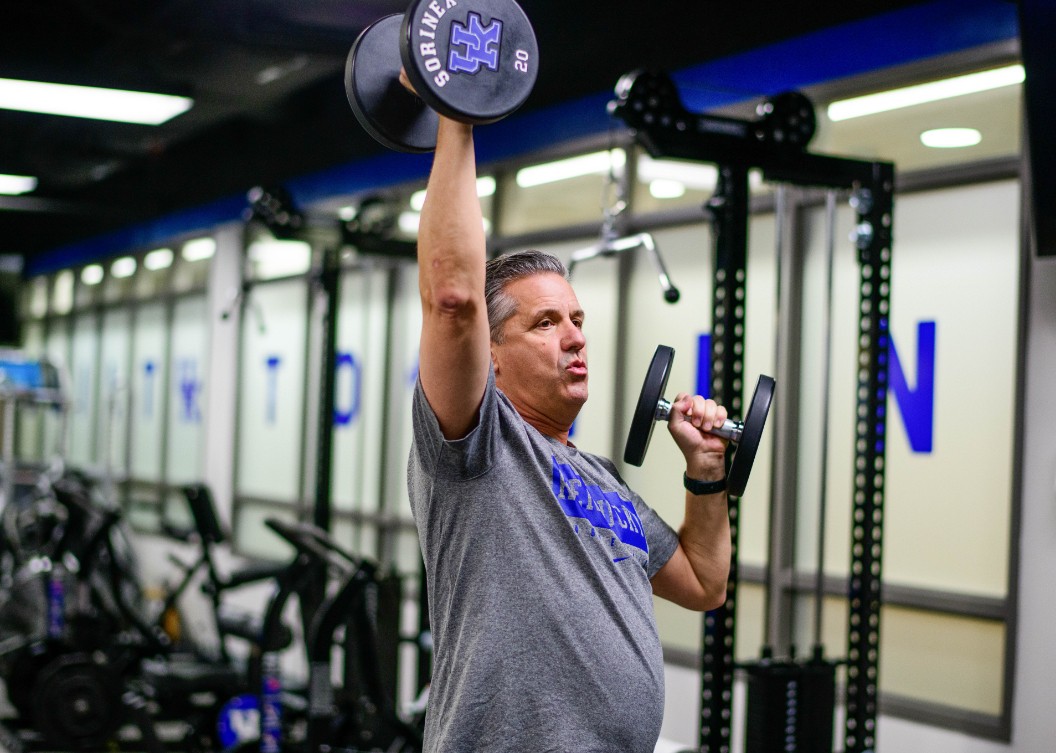 Coach Cal lifts two 20lb dumbbells at the UK gym