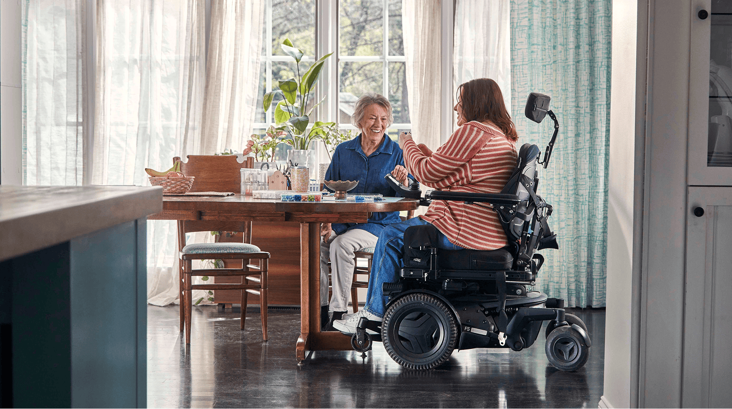 Alison making bracelets at home after regaining fine motor skills